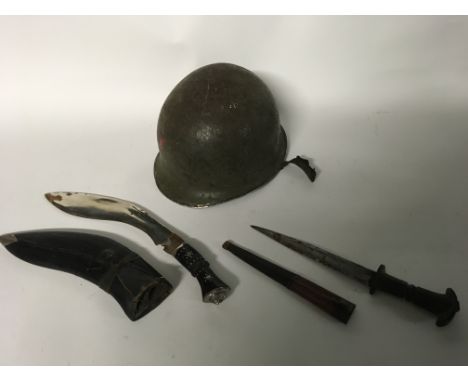 A small group of items to include a US WW2 military helmet a hunting knife with a leather scabbard and a Kukri knife with sca