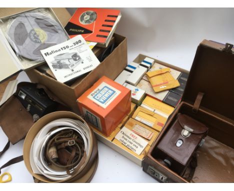 A collection of cinema and camera equipment, including a still projector and slides of various views and images