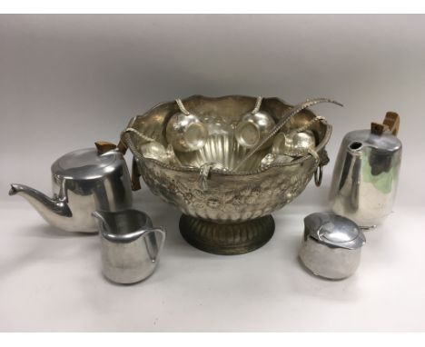 A silver plated punch bowl and a four piece Picquot ware tea and coffee service.