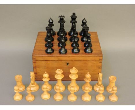 A Staunton pattern chess set, natural and black, king 9cm, in a mahogany box with a Staunton label