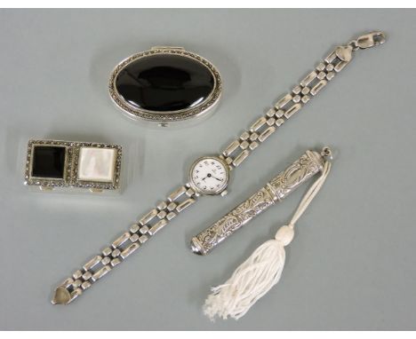 A sterling silver oval pillbox, with onyx and marcasite set lid, a sterling silver rectangular twin pillbox with onyx, mother