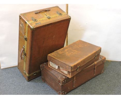 An early 20th century Jaime Bratt, Buenos Aires, hard vulcanised fibre valet trunk, and two further suitcases