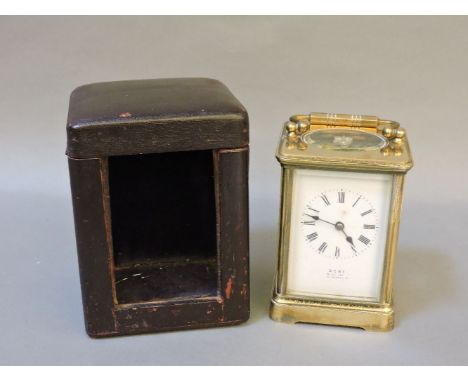 A brass carriage clock, by Dent, in original leather case, clock 16cm high
