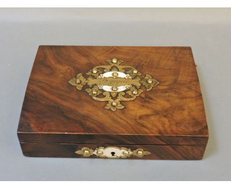 A Victorian walnut card box, the brass mount stamped 'Bezique' containing four racks of playing cards and three bezique scori