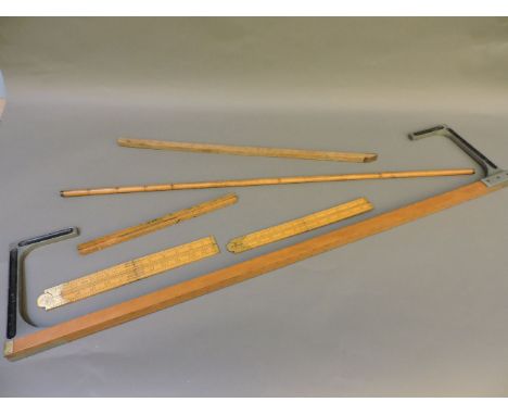 Six various wooden rules and measures, including two folding 'Rabone' carpenters' rules, and liquid volume measuring stick
