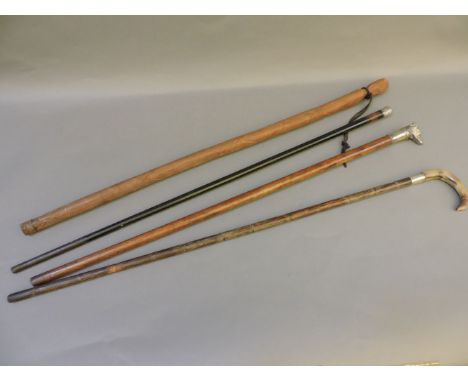 Four walking sticks, one with a plated dog head grip, two with silver mounts, and an African stick