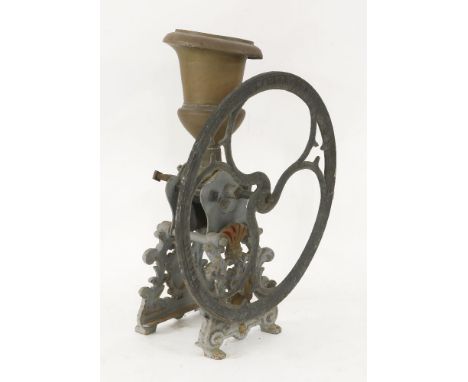 An iron coffee grinder, with a copper funnel and cast iron wheel, stamped 'Bartlett and Son, Makers, Bristol', 77cm high
