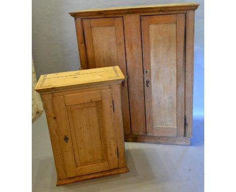 A 19th Century Pine Hall Cupboard The Moulded Top above two panel doors enclosing shelves, together with another similar smal