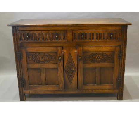 A 20th Century Oak Dresser Base With Two Drawers above two carved panel doors, flanked by stiles, 129cm wide, 48cm deep, 91cm