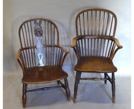 An Early 19th Century Windsor Armchair With A Spindle Back above a shaped panel seat, raised upon turned legs with stretchers