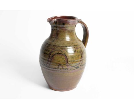 ARR Ray Finch (1914-2012) Winchcombe Pottery a stoneware jug of baluster ribbed form in khaki and brown glaze with central co