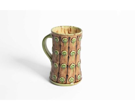 ARR Paul Young (Contemporary) a slip decorated tankard with sprigged decoration in brown and green glazes, 17cm x 10cmSome cr