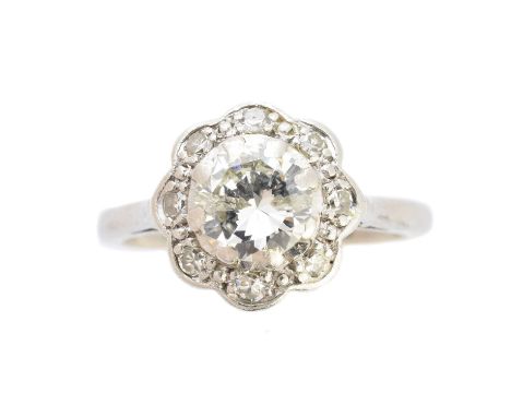 A diamond cluster ring, of floral design, the brilliant cut diamond within a single cut diamond scalloped surround, estimated