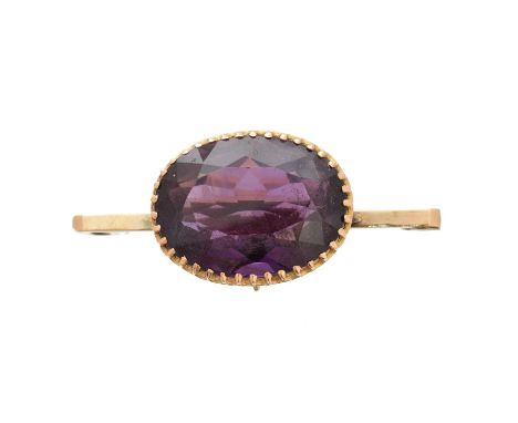 An amethyst brooch, the oval shape amethyst collet atop the later bar brooch, setting stamped 15ct, brooch stamped 9ct, lengt