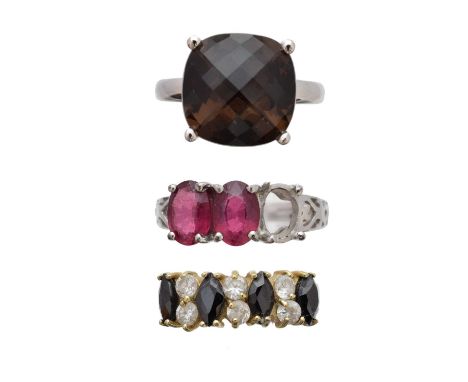 Three gem-set dress rings, to include a 9ct gold pink tourmaline three stone ring, a sapphire and colourless paste band ring 