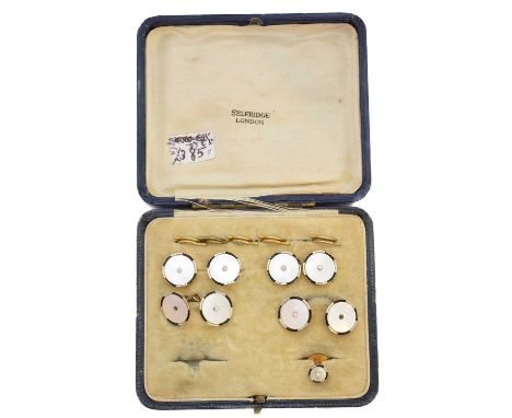 An early 20th century cased set of dress studs retailed by Selfridges, the mother of pearl, seed pearl and enamel cufflinks a