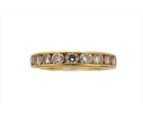 An 18ct gold diamond band ring, the brilliant cut diamond line within a channel setting, hallmarks for Birmingham, estimated 