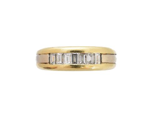 A diamond band ring, of bi-colour design, the baguette-cut diamond line inset to the grooved band, estimated total diamond we
