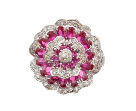 A ruby and diamond cluster ring, of floral design, the brilliant-cut diamond and vari-cut ruby floral cluster atop the replac