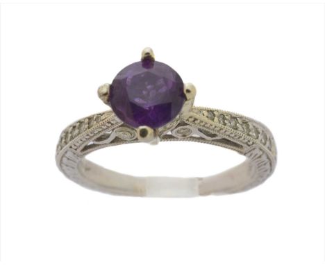 An amethyst and diamond dress ring, the circular shape amethyst with vari cut diamond tapered shoulders, stamped 585, estimat