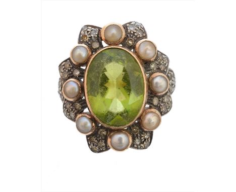 A peridot split pearl and diamond dress ring, the oval shape peridot within a circular shape split pearl and single cut diamo