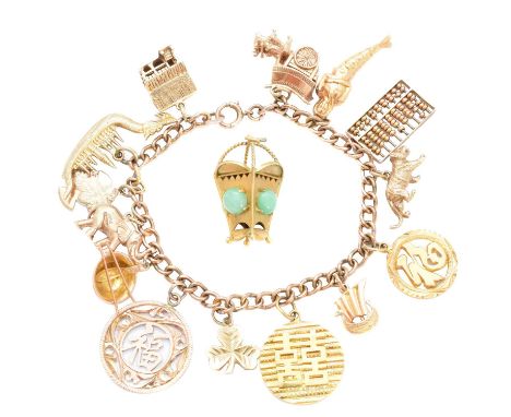 A charm bracelet, the flat curb link chain suspending fourteen charms to include an abacus, a ramen bowl, a tiger and a merma