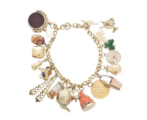 A charm bracelet, the curb link chain suspending eighteen charms to include a carved coral Buddha, an Edward VII half soverei