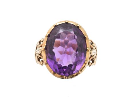 An amethyst single stone ring, the oval shape amethyst with scrolling openwork gallery and shoulders, ring size J1/2, gross w