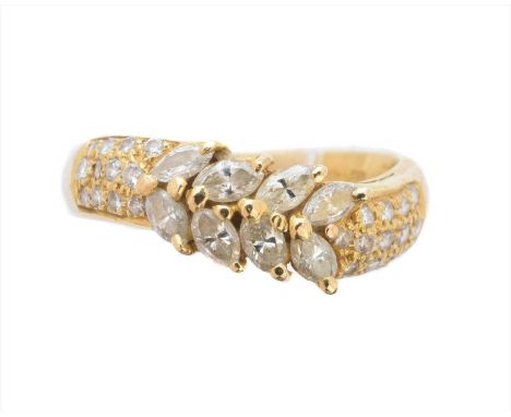 An 18ct gold diamond band ring, of undulating design, the marquise cut diamond line with brilliant cut diamond shoulders, imp