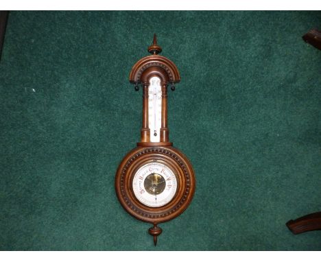A Victorian walnut barometer, 23" high overall.