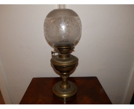 A Victorian brass oil lamp with shade, 19" high overall.