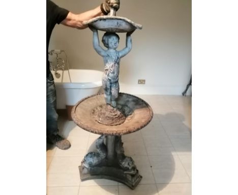 A 19thC lead garden fountain, a putto holding a small basin, surmounting a circular tier supported by three dolphins,  66" hi