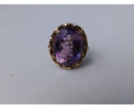 A large oval amethyst single stone ring in 9ct gold.  Finger size K/L.