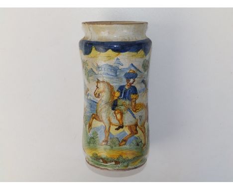 An antique maiolica albarello, painted with a landscape panel in blue, green, ochre &amp; yellow, depicting a nobleman on hor