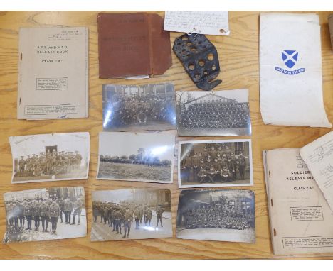 Eight WWI photographic postcards depicting army units, three WWII army release books and a piece of WWII shrapnel.