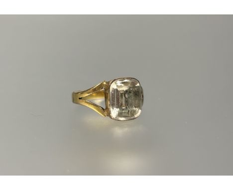 A yellow metal ring set pale cushion cut stone mounted in rub over setting appriximatey 3ct: P 2.38g