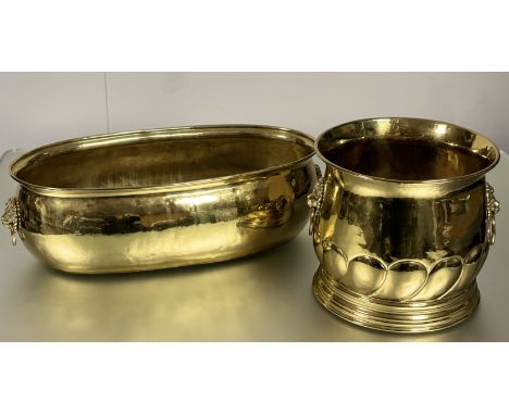 A brass hammered finish oval planter with lion's head ring handles to both sides (h-18cm l-58cm) togther with a brass hammere