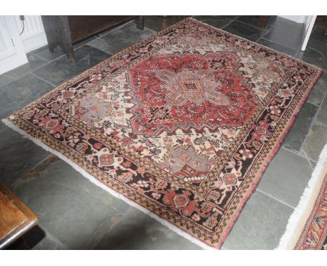 A Middle Eastern woollen carpet, with central medallion and stylised scrolls, 208cm x 157cm. 