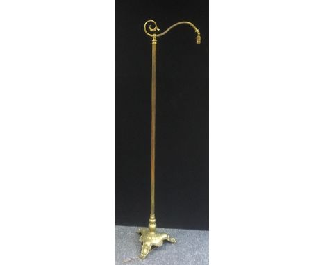 A brass standard reading lamp with three claw feet c.1920 