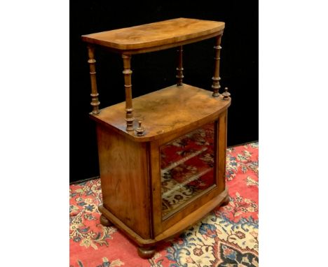 A Victorian bowfront walnut music cabinet, shelf with turned supports to superstructure, glazed door enclosing shelving to ba