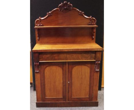 A Victorian mahogany chiffonier, shaped and carved gallery with single shelf to top, long drawer over two door cupboard to ba