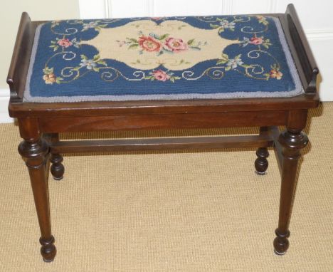 A late 19th century mahogany piano stool,  with tapestry top, cylindrical legs, H stretcher, 50cm high, 61cm wide, c.1890 