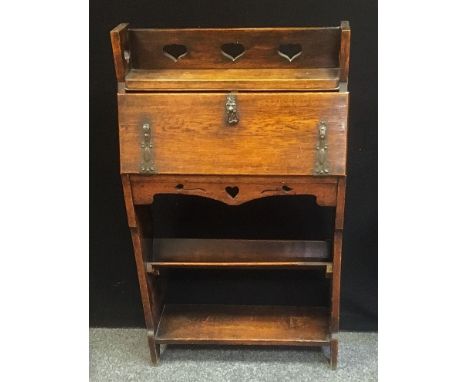 An Arts &amp; Craft oak students Bureau, Heart pierced book rack top,  locking fall front, ornate strapwork hinges, enclosing
