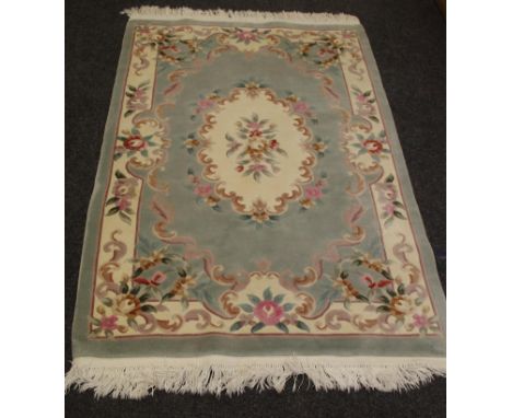 A handwoven carpet, geometric designs on a red ground, 240cm x 142cm; another carpet, floral designs on a taupe ground. 193cm