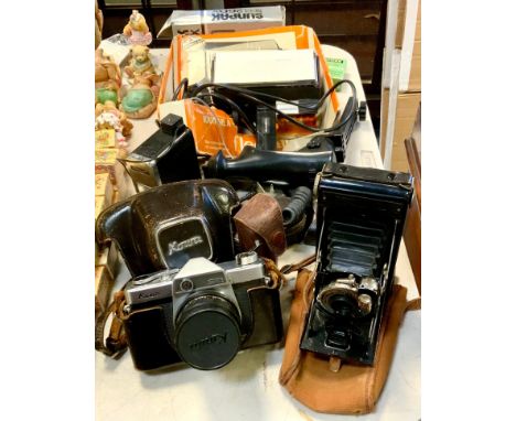 A Coronet bellows camera; a Kowa SE 35mm SLR camera, 50mm lens, flash adapters, light meter etc quantity 