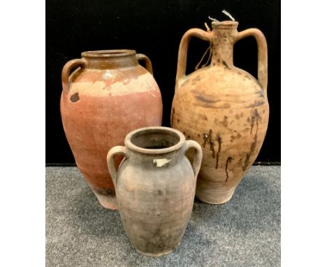 A twin handled amphora bottle flask, incised trailing banded shoulders, 58.5cm high;  other smaller vases (3) 