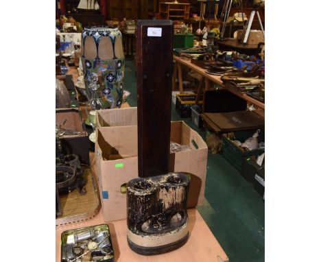 A late 19th century stoneware umbrella stand, for two umbrellas and with water receptacle and wooden bracket. 70cm high 
