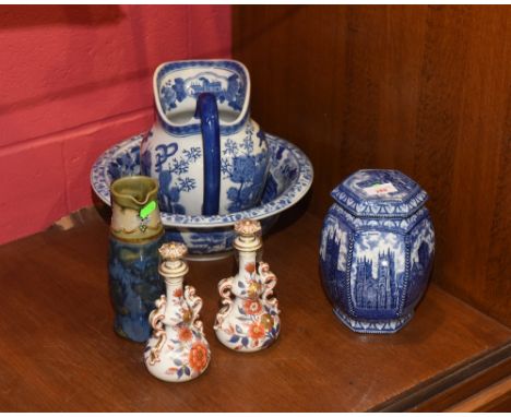 A slender Royal Doulton stoneware jug together with a pair of porcelain scent bottles and stoppers decorated in the Imari pal