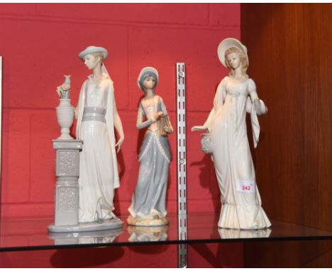 Two Lladro figures of young ladies, 35cm high and a Casades porcelain figure of a girl holding a lute (3)