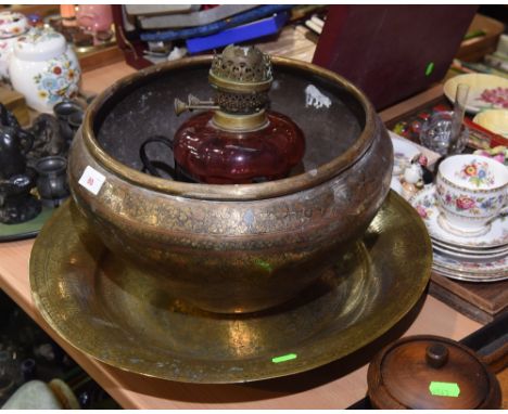 A Middle Eastern brass tray and jardiniere; tog, with a 19th century wrought iron and cranberry glass oil lamp